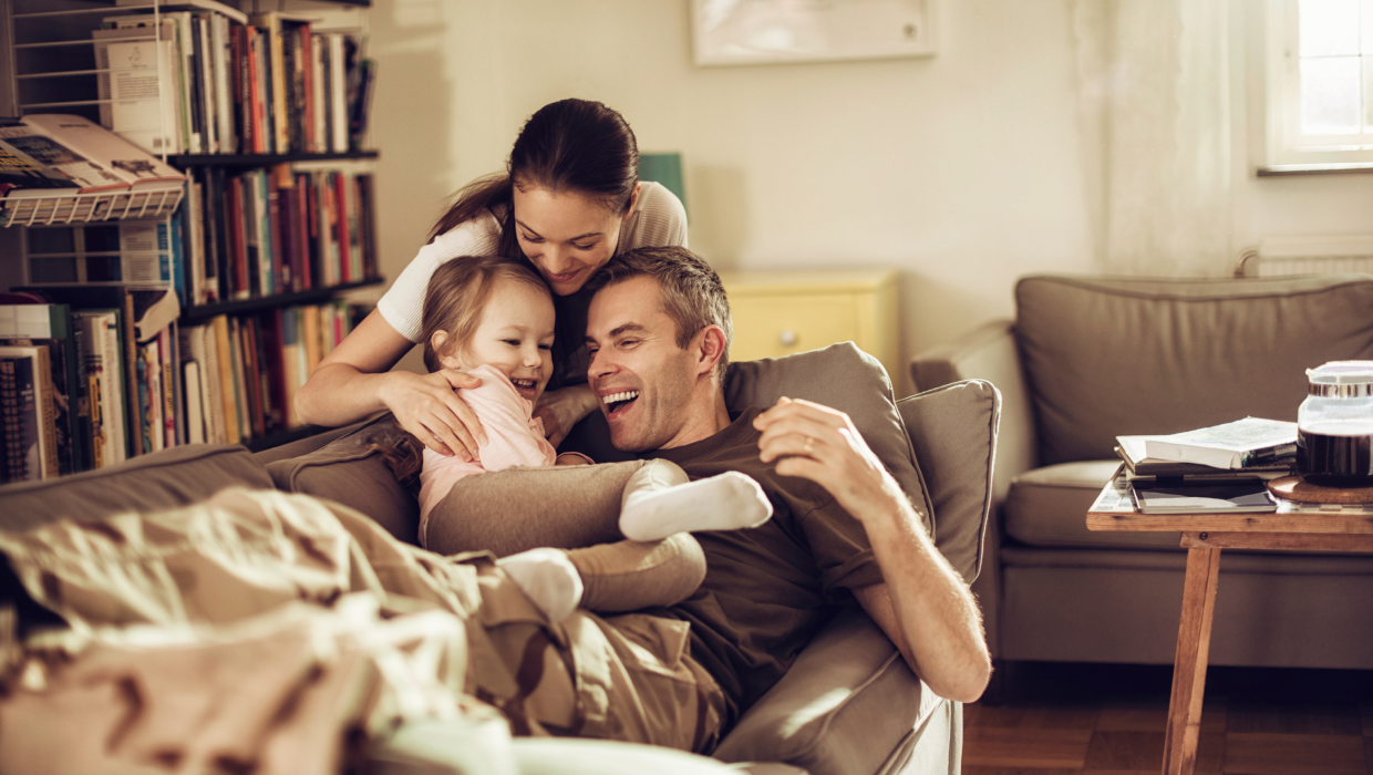 Young parents with child on the sofa